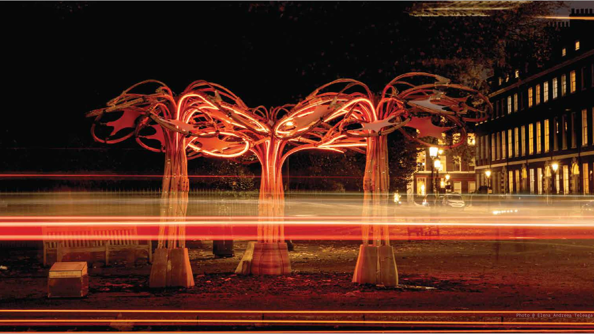 The illuminated rattan pavilion photographed at night.